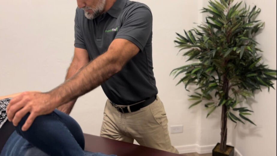 Dr. Jesus Bernal performing assisted stretch therapy on a patient at MueveFlex Wellness Center in Tucson, Arizona