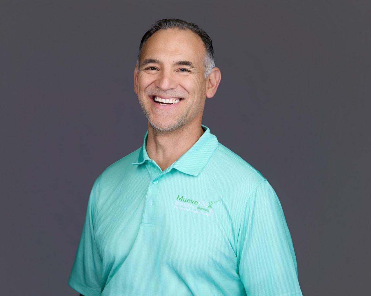 Dr. Jesus Bernal demonstrates hip mobility and standing posture guidance, MueveFlex Wellness Center Tucson